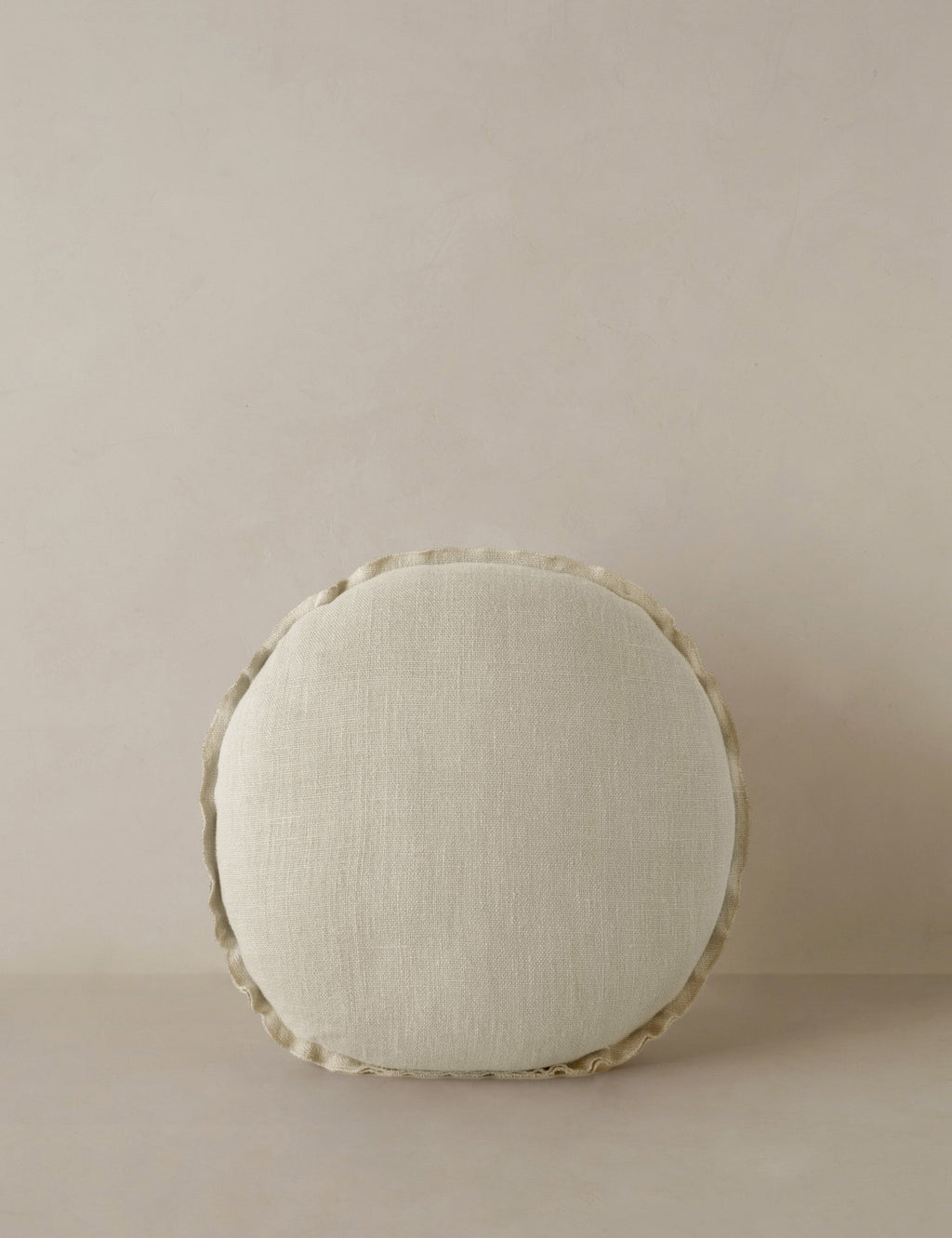 #color::light-natural | Arlo linen flange trim round pillow.